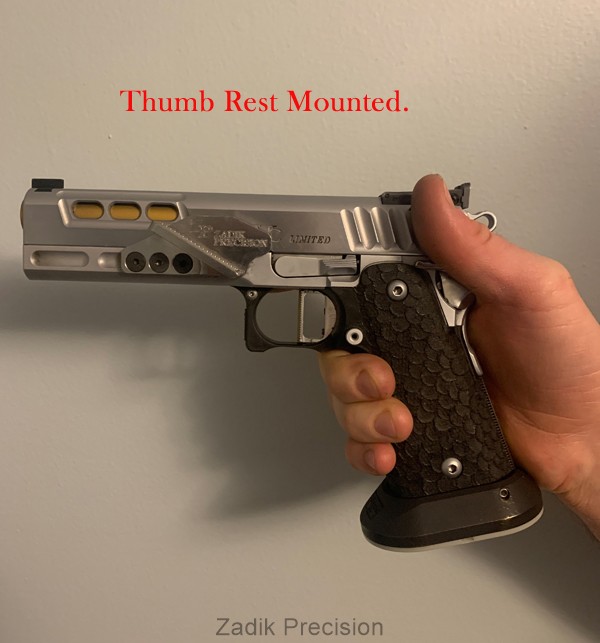 Thumb rest mounted on firearm.